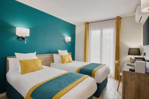 Katil atau katil-katil dalam bilik di Best Western Le Vauban