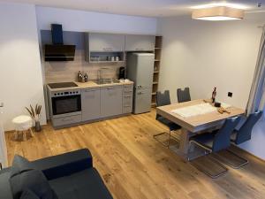 a kitchen and dining room with a table and chairs at Seereith Apartments in Brixen im Thale