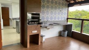 a kitchen with a sink and a counter top at Katuny Pousada e Eventos in São Domingos do Prata