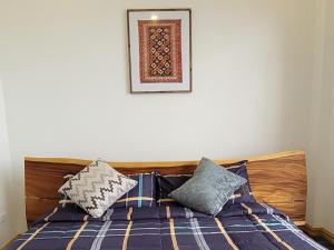 a bedroom with a bed and a picture on the wall at Beachfront Bed & Breakfast in San Jose