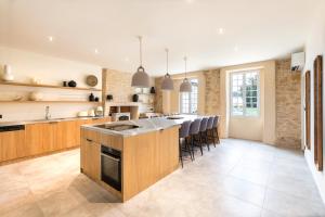 a kitchen with a large island with a counter top at Château de Callac in Illats