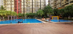 a group of people in a swimming pool in a city at BayView Villas Condo - Premium Unit in Port Dickson