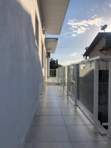 an empty balcony of a building with a walkway at Suíte privativa proxima ao Sesc 2 in Bertioga