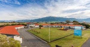 an aerial view of a building with mountains in the background at Kaikoura Motor Inn in Kaikoura