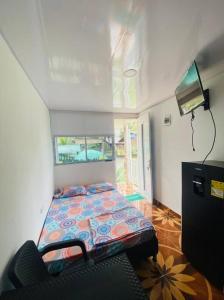 a small bedroom with a bed in a room at VIDAMAR, JUANCHACO. LADRILLEROS, LA BARRA in Playa Ladrilleros