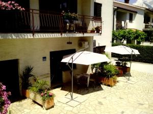 two white umbrellas sitting outside of a building at Apartments Peloža in Poreč