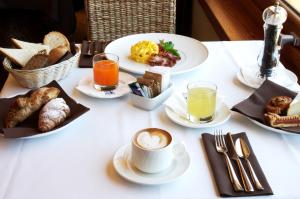 a white table with breakfast foods and drinks on it at Hotel La Perla Del Golfo in Procchio