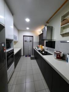 a kitchen with white tile flooring and a large kitchen at HillTree Homestay Putrajaya in Putrajaya