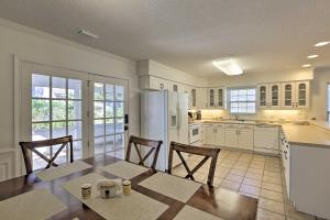 a kitchen with a table and chairs and a refrigerator at Seagrass Cottage Less Than 1 Mi to Fishing, Boating in Steinhatchee