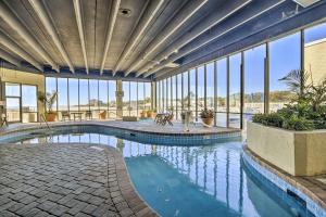 a large swimming pool in a building with windows at Dreamy Beach Condo with Views and Amenity Access! in Myrtle Beach