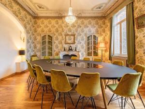a dining room with a table and chairs at Luxury holiday home in Vloesberg with sauna and hot tub in Flobecq