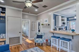 a kitchen and living room with a ceiling fan at Central Cottage with Grill, 1 Mi to Cajun Field in Lafayette