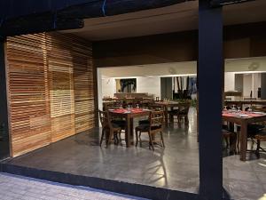 a dining room with wooden tables and chairs at Golden Star Beach Hotel in Negombo