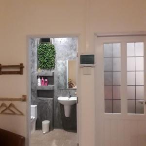 uma casa de banho com um lavatório, um WC e um espelho. em Baan Be Beach em Lang Suan