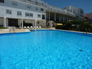 a large blue swimming pool in front of a building at Hotel La Terraza in Sanxenxo