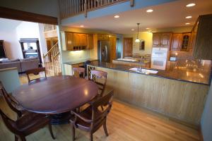 a kitchen and dining room with a wooden table at Hill View Motel and Cottages in Lake George