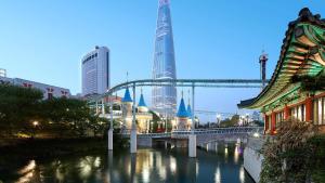 a large building with a clock on top of it at Lotte Hotel World in Seoul