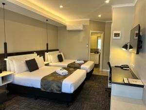 En eller flere senge i et værelse på Best Western Melbourne Airport