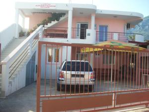 a car parked in front of a house with a gate at Lukic Apartmani in Bar