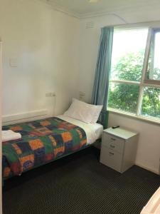 Postel nebo postele na pokoji v ubytování Evancourt Motel Malvern East