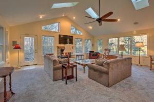 a living room with two couches and a ceiling fan at Sugar Grove Escape with Hot Tub and Grill! in Sugar Grove