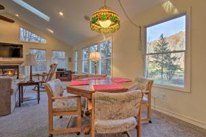 a dining room and living room with a table and chairs at Sugar Grove Escape with Hot Tub and Grill! in Sugar Grove