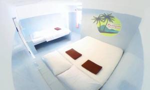 Postel nebo postele na pokoji v ubytování Phangan Mantra Inn