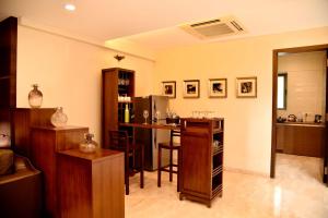 a living room with a bar and a kitchen at Mizzle in Lonavala