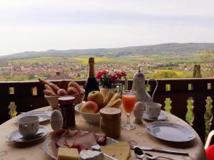 a table with food and a bottle of wine and bread at Ferienhaus Talblick in Fladungen