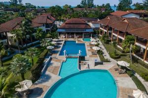 an aerial view of a resort pool with umbrellas at The Leaf Oceanside by Katathani - SHA Extra Plus in Khao Lak
