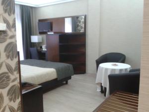 a hotel room with a bed and a small table at Hotel San Giorgio in Sangano