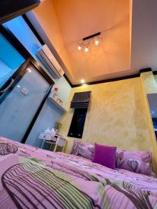a bedroom with a purple bed and a large window at คูร์โดวเเอนด์เเซนด์วิลล่า in Khiriwong +59 photos