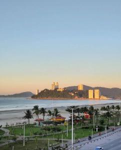 a view of a beach with a city and the ocean at OYO Hotel Céu Azul, São Vicente in São Vicente