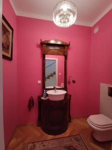 a bathroom with pink walls and a sink and a mirror at Villa Art deco in Dębica +44 photos