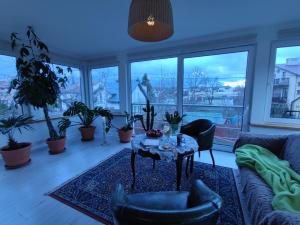 a living room with a table and chairs and windows at Villa Art deco in Dębica
