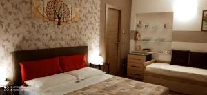 a bedroom with a bed and a dresser in it at IL CORTILETTO - Verduno in Verduno +33 photos