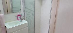 a bathroom with a sink and a shower at Neviot in Eilat +19 photos