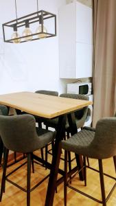a dining room table with chairs and a chandelier at Casa Caterina in Mantova +15 photos