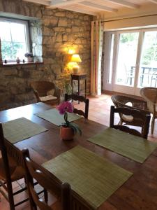 a dining room with a wooden table and chairs at Le clos Saint Aubin in Carnac