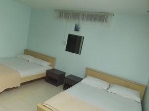 Postel nebo postele na pokoji v ubytování Hotel Permai Melaka Raya