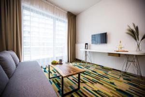 a living room with a couch and a table at Aleja Baltic Park Molo 308 in Świnoujście