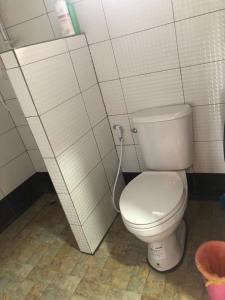 a bathroom with a white toilet in a stall at บ้านทองอาทรเขาค้อ in Khao Kho