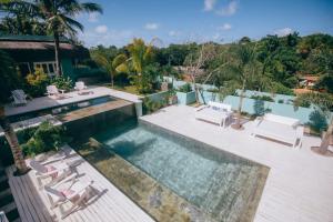 an aerial view of a swimming pool with lounge chairs and a swimming pool at Cactus Lodge Pipa in Pipa