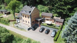 an aerial view of a large house with parked cars at B&B Villa Altero in Pünderich