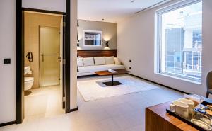 a living room with a couch and a window at FORM Hotel Dubai, a Member of Design Hotels in Dubai