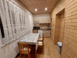 a kitchen with a table and chairs in a room at Penzion Emílie in Jeseník