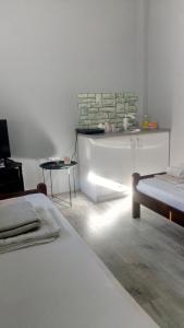 a white room with two beds and a table at Happy Star in Niš