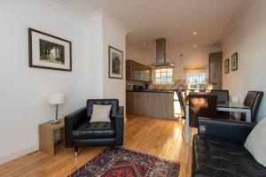 a living room with a couch and a chair at Apartment 4 The Grove in Durham