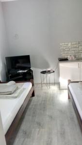 a room with two beds and a piano at Happy Star in Niš