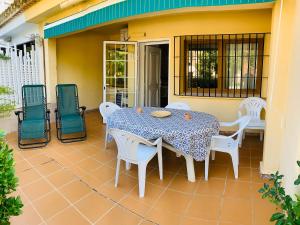 a patio with a table and chairs on a house at CASA DUPLEX BUNGALOW Dénia in Denia